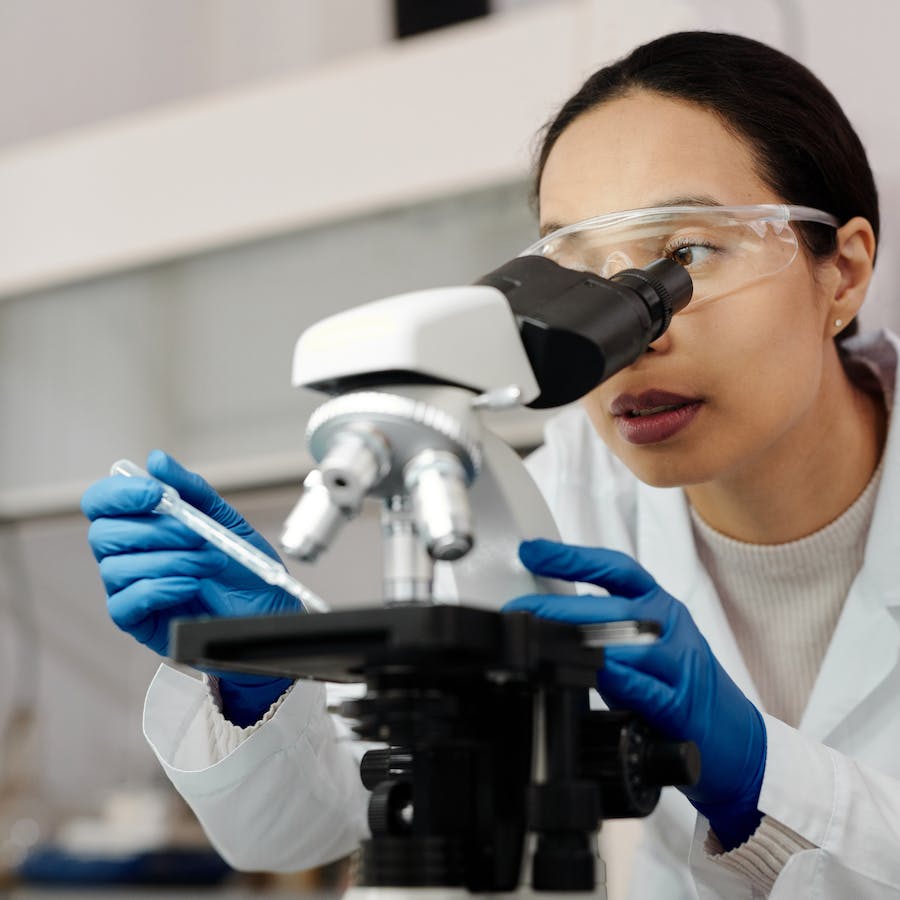 Woman using a microscope for medical research